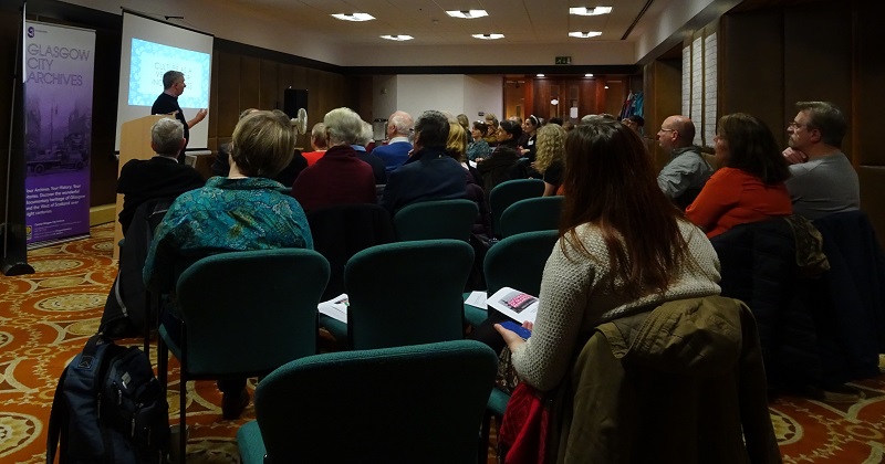 Study day 1 photo 3: presenters giving their talk to an audience seated theatre-style in the Blythswood Room, Mitchell Library