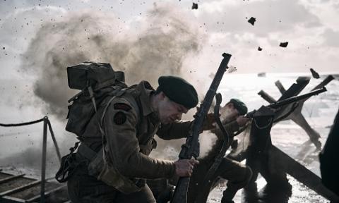 Explosion scenes on "Sword Beach", soldiers under fire as they run from the landing craft onto the beach through Czech hedgehog anti-tank obstacles