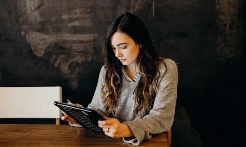 Young, female teacher on her laptop preparing for lessons