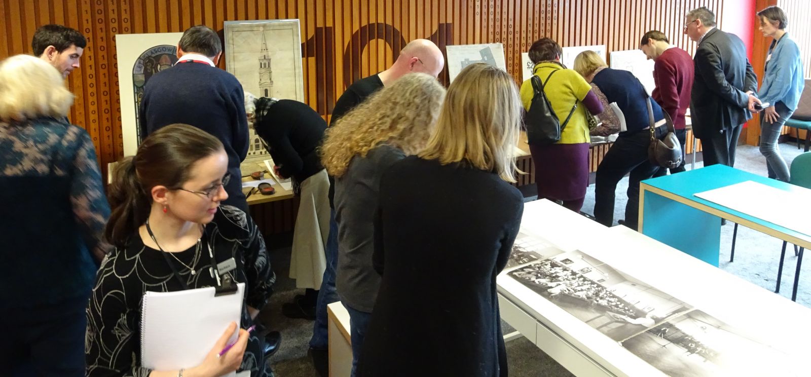 Photograph show members of the network viewing documents from the Glasgow City Archives collection