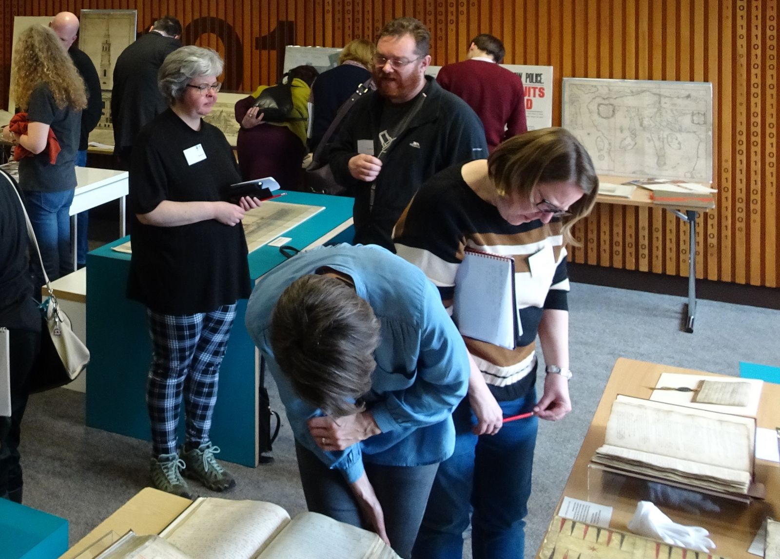 Photograph show members of the network viewing documents from the Glasgow City Archives collection