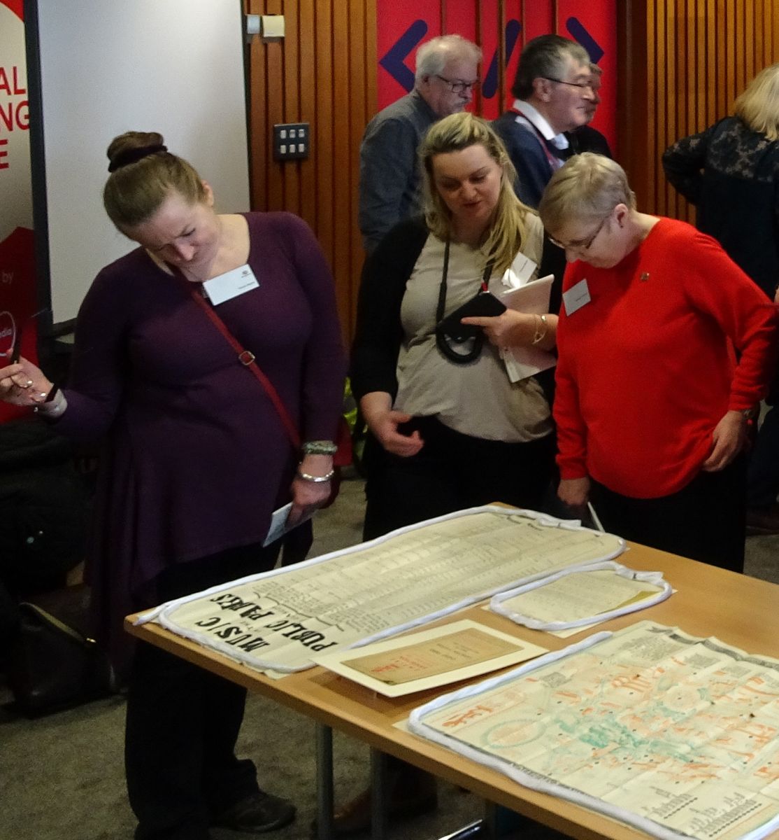 Photograph show members of the network viewing documents from the Glasgow City Archives collection