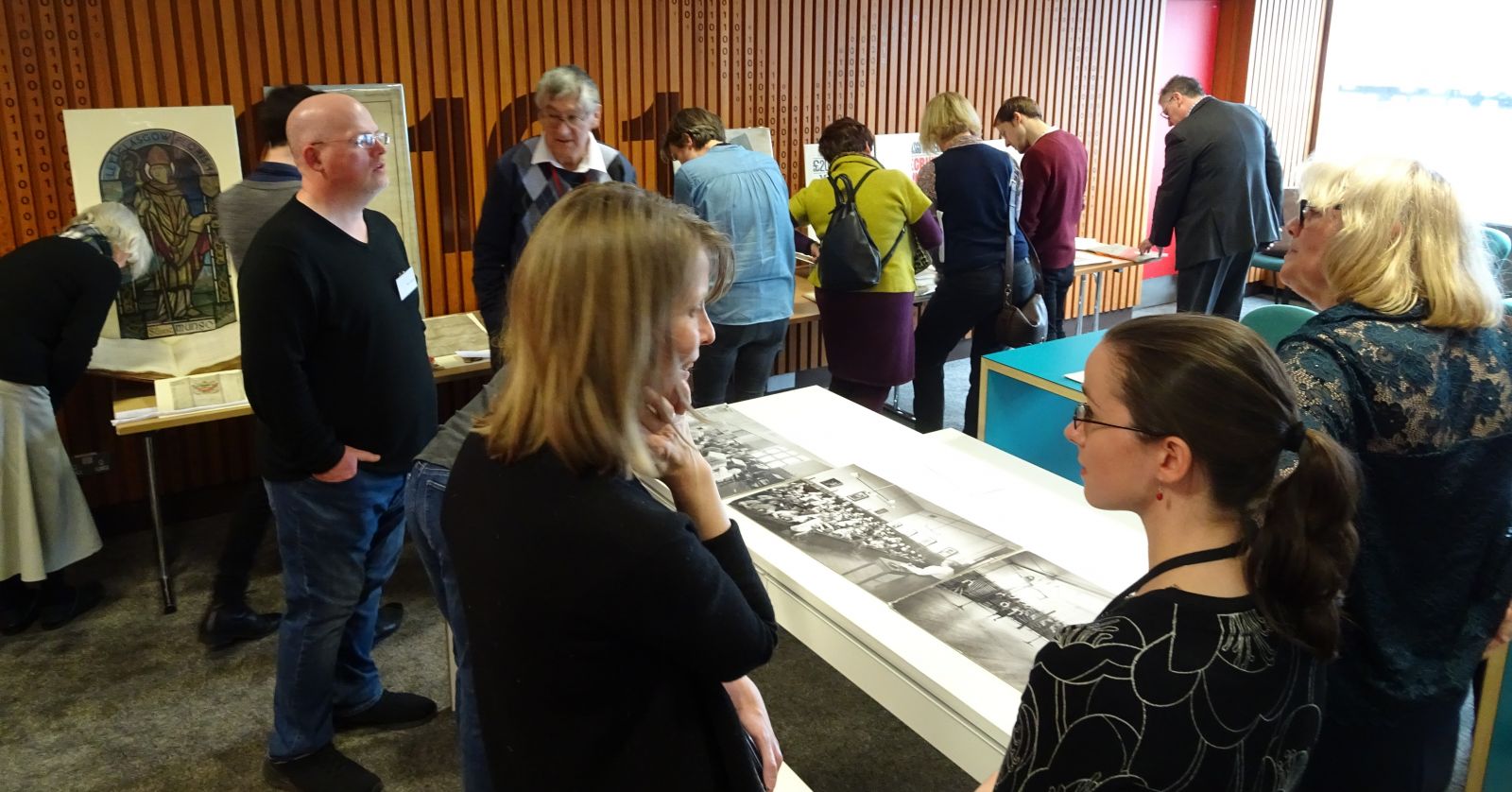 Photograph show members of the network viewing documents from the Glasgow City Archives collection