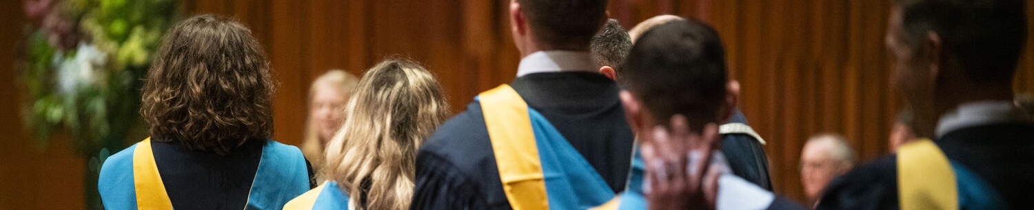 The back of students at OU graduation ceremony