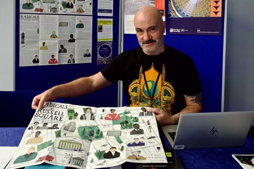 Donall Mac Cathmhaoill (English and Creative Writing) shows posters in front of a poster wall