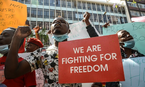 A Ugandan protester displays a place card reading WE ARE FIGHTING FOR FREEDOM  during a protest in Nairobi, Kenya, November, 2020