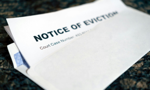 A folded letter with the word 'notice of eviction' partly tucked into an envelope.
