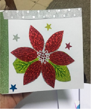 A red Christmas flower crafted for a Christmas card