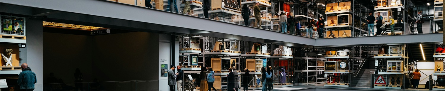 People in a large museum with stacked exhibits