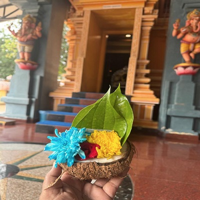 Dr. Nithiya was holding Tenga Archanai after her ancestral prayers in the temple
