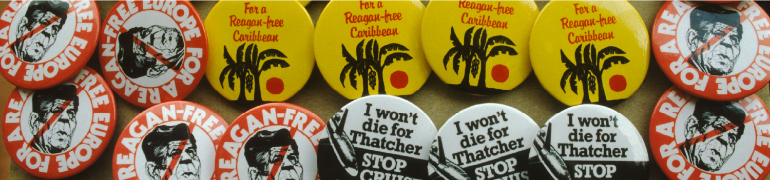 various badges pinned to a board with different message 'free Europe for a Reagan', 'For a Reagan-free Caribbean' and 'I won't die for Thatcher' 
