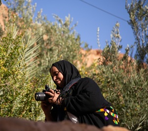 Person taking photos with camera in nature 
