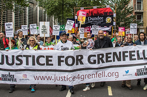 Demonstrators stage a protest in central London to demand justice on the second anniversary of the Grenfell Tower fire