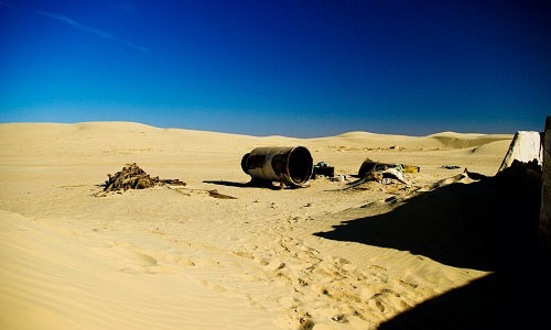 A photograph showing film props that have been left after a shoot as debris in the Tunisian desert