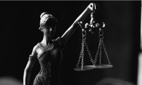 A Grayscale of a Lady Justice Figurine