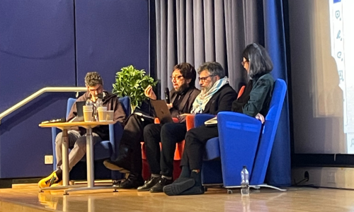 Conference participants seated in the lecture theatre and in dialogue at the launch event