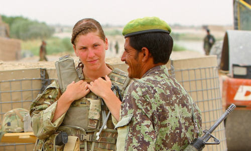 Able Seaman Heidi Telford converses with an Afghan soldier at the southern side of the Nahr-e-Bughra Canal, near Checkpoint Salaang, Helmand province, June 11.