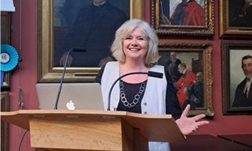 Elizabeth McKellar speaks in front of audience