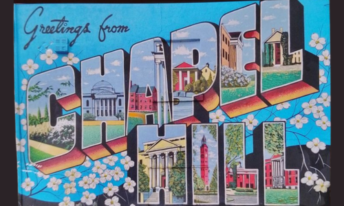 Colorful postcard reading 'Greetings from Chapel Hill' in large, bold letters. Each letter in 'Chapel Hill' features images of local landmarks from Chapel Hill, North Carolina. The background is blue with white flowers, and the postcard rests on a surface with a green leaf pattern.