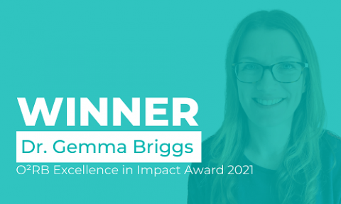 Dr Gemma Briggs behind Teal background with ‘Winner O2RB Excellence in Impact Award 2021’