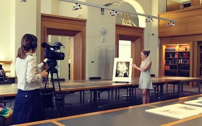 Photo of Dr Leah Clark being filmed in the Victoria and Albert museum, London