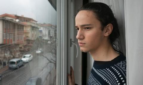 person alone next to window