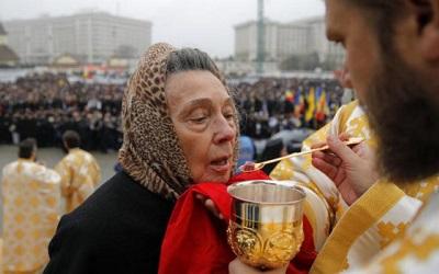 Romanian lady taking communion