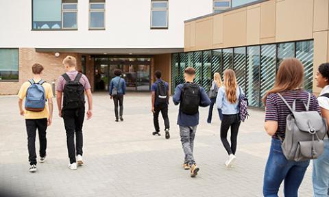 Young people walking into school or college building