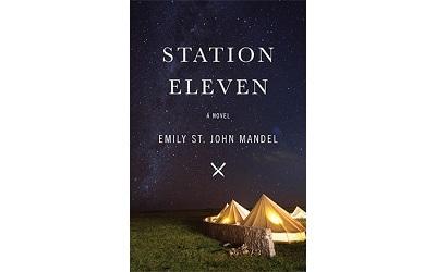 Image shows the front cover of the book Station Eleven which shows tent-like images on grass under a dark sky