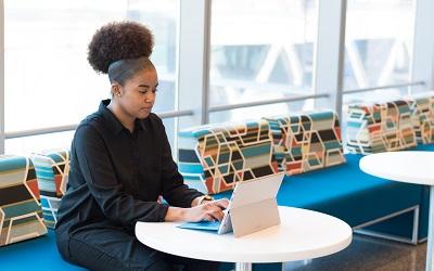 Photo by Christina @ wocintechchat.com on Unsplash - female using a laptop in an open, bright room