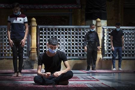 Iraqi youth praying inside the shrine of Al-Abbas