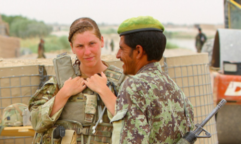 Able Seaman Heidi Telford converses with an Afghan soldier at the southern side of the Nahr-e-Bughra Canal, near Checkpoint Salaang, Helmand province, June 11.