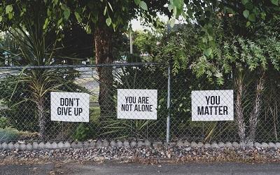 Hopeful sign on the road reminding people not to give up