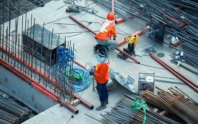 Men working on a construction site with masks on