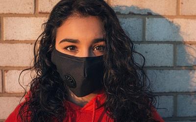 Photo by Gayatri Malhotra on Unsplash - young woman with beautiful brown eyes staring at the camera with a black mask on