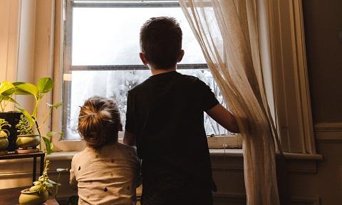 Children looking eagerly out the window