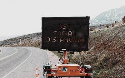 COVID-19 road sign reminding people of social distancing