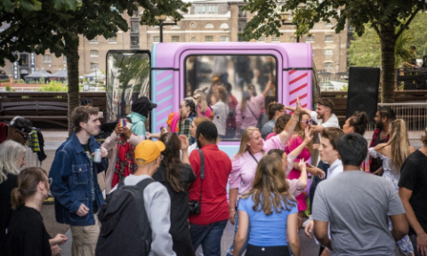 Young people in bright clothing attending an arts event outside