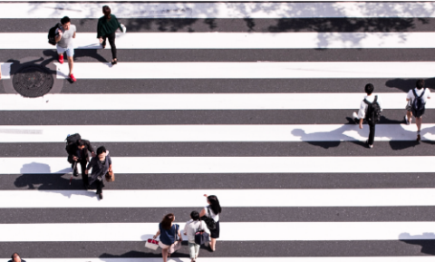 People walking across a cross roads
