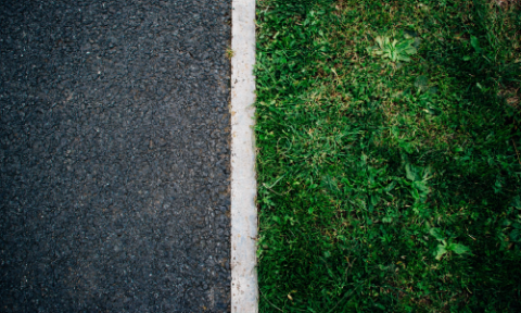 Road edge which meets the grass line, bordered by a white line