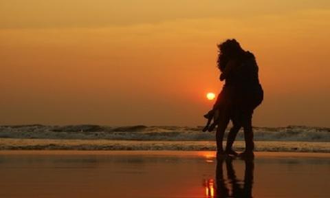 couple hugging with a sunset background