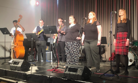 Six students from The Open University performing on stage at the Trinity Laban Conservatoire of Music and Dance.